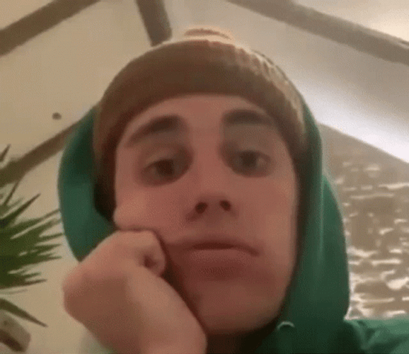 Justin Bieber With His Hands On His Cheek GIF