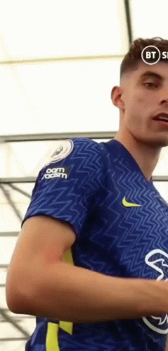 Kai Havertz Flexing His Team Logo On His Shirt GIF