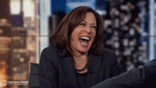 Kamala Harris Is Laughing While Sitting On A Stage . GIF