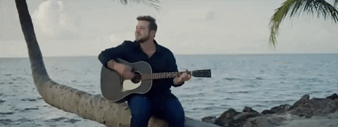 Kameron Marlowe Playing Guitar On Palm Tree GIF
