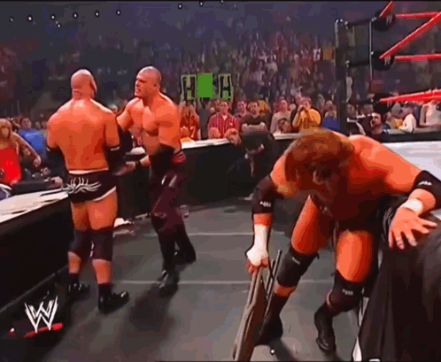 Kane Chokeslam Goldberg On Announcers Table GIF