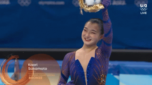 Kaori Sakamoto Is Holding A Trophy In Her Hand GIF