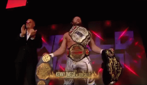 Kenny Omega Holding Two Championship Belts