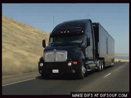 Kenworth Semi Truck Driving Down Highway