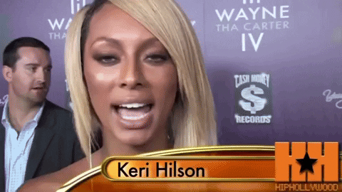Keri Hilson Standing in Front of Cash Money Records Sign