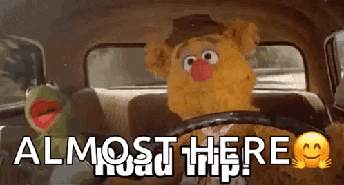 Kermit The Frog And Fozzie Bear Are Sitting In The Back Seat Of A Car With The Words Almost Here Written On The Bottom GIF