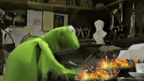 Kermit The Frog Is Cooking Something In A Frying Pan GIF