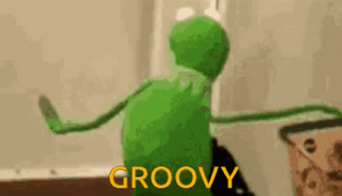 Kermit The Frog Is Dancing In A Room With The Words `` Groovy '' Written On The Bottom . GIF