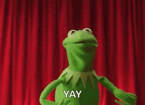 Kermit The Frog Is Dancing On Stage In Front Of A Red Curtain And Saying Yay . GIF