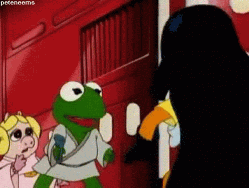 Kermit The Frog Is Standing Next To Miss Piggy And A Black Penguin . GIF