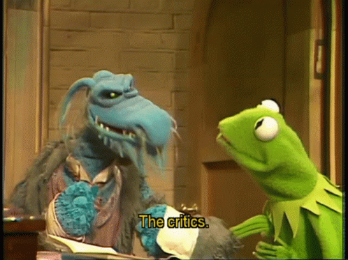 Kermit The Frog Is Talking To A Blue Monster With The Words The Critics Below Him GIF