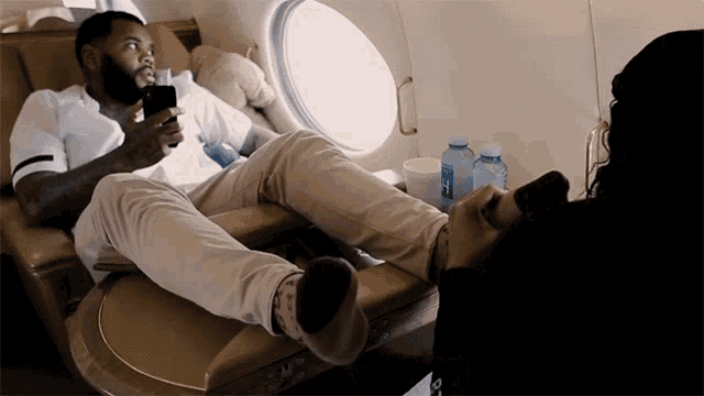 Kevin Gates Gets Foot Massage On Flight GIF