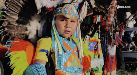 Kid As Tribal Chief Handing Stick GIF