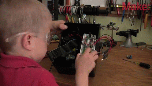 Kid Playing Electronics GIF