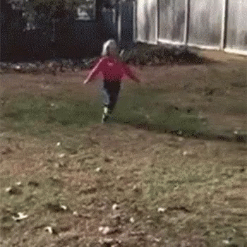 Kid Playing Piled Falling Leaves GIF