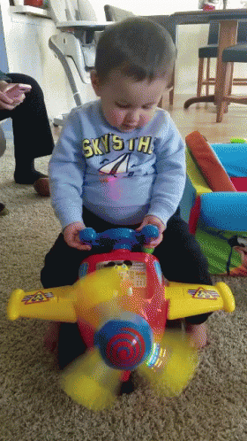 Kid Playing Small Plane Toy GIF