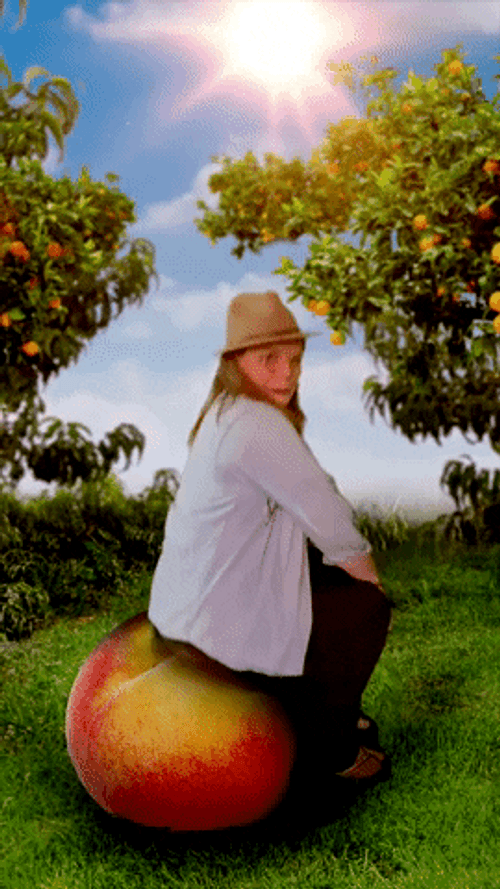 Kid Sitting On Bouncing Peach GIF