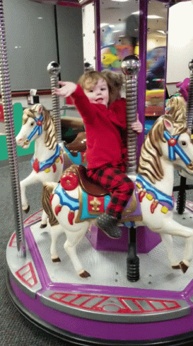 Kid Waving From Merry Go Round GIF