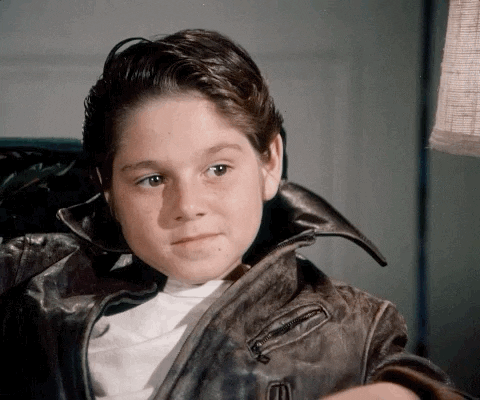 Kid Wearing Jacket Agree While Seating GIF