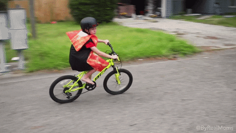 Kid Wearing Pizza Costume Riding Bike GIF