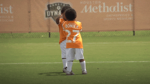 Kids Embracing Each Other In Field GIF