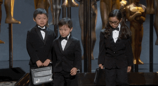 Kids Wearing Tuxedo And Carrying Briefcase GIF