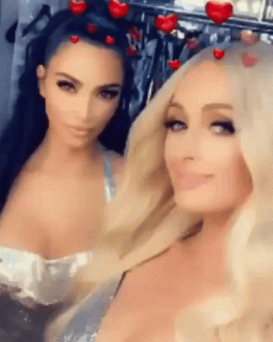 Kim Kardashian And Paris Hilton Are Posing For A Picture Together . GIF