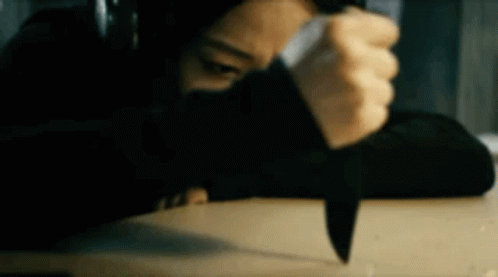 Kimiko With Headphones Holding A Knife GIF