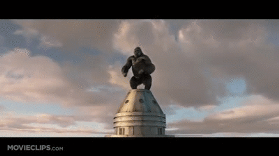 King Kong Beating His Chest Standing On Top Of Building GIF