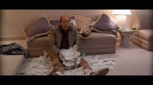 Kingpin Woody Harrelson Tossing Money GIF