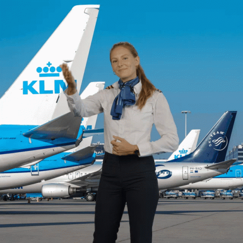 KLM Flight Attendant Standing in Front of Planes