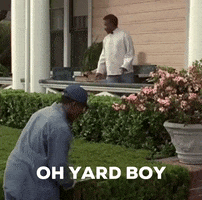 Kneeling Man in Front of House with Oh Yard Boy