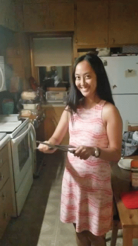Woman With Scary Smile While Sharpening Knife GIF