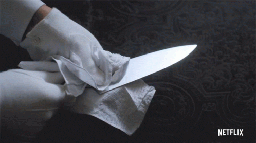 Cleaning A Knife With Tissue Paper GIF