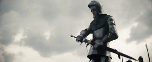 Knight in Armor Holding Sword Before Cloudy Sky