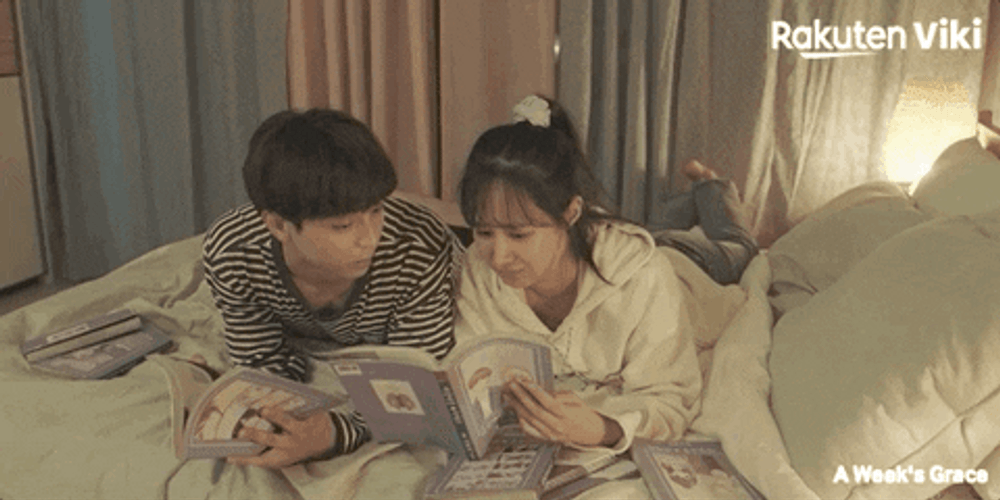 Korean Dreama Couple Reading And Cuddling In Bed GIF