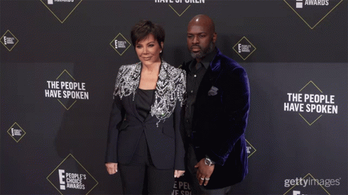 Kris Jenner And Her Husband Pose On A Red Carpet For The People 'S Choice Awards GIF