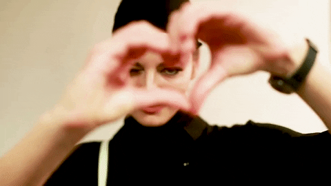 Lady In Black Heart Hands On Right Eye GIF