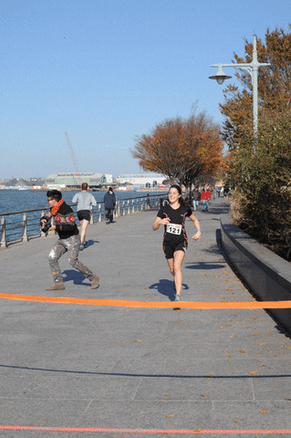 Lady Runner Happily Reaching Finish Line GIF