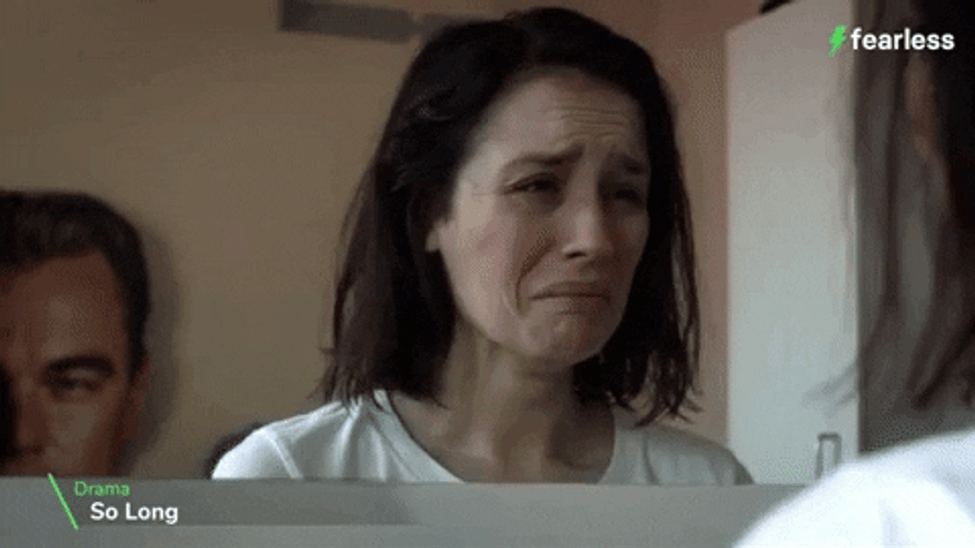 Lady Trying Not To Cry In Front Of Mirror GIF