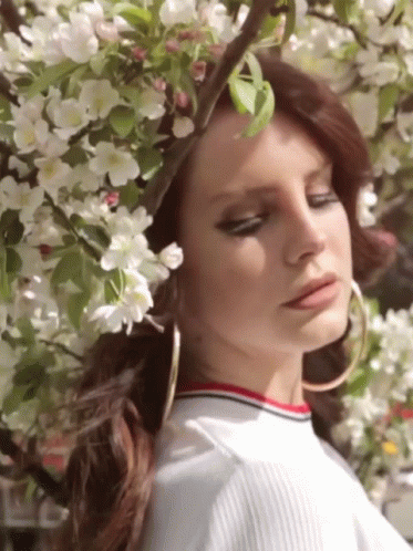 Lana Del Rey Posing On Flowers GIF