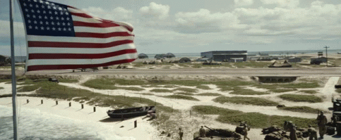 Large American Flag Flying Over Small Island