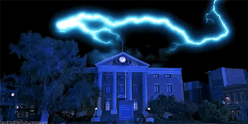 Large Building With Clock And Lightning GIF