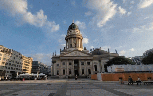 Large Building With Dome and Statue on Top