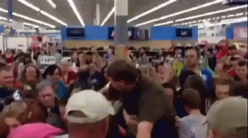 Large Crowd in Store With 5 Sign