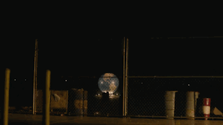 Large Explosion Behind Fence in Parking Lot