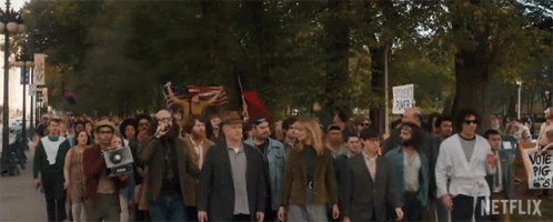 Large Group Marching With Netflix Sign GIF