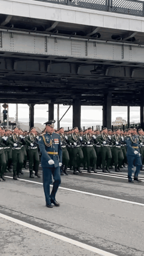 Large Group of Soldiers Marching Down Street