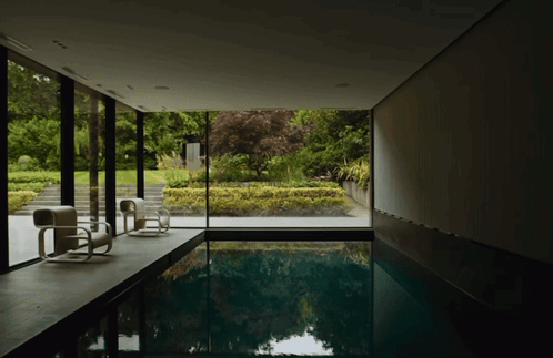 Large Indoor Swimming Pool Surrounded by Window