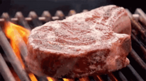 Large Steak Cooking on Grill